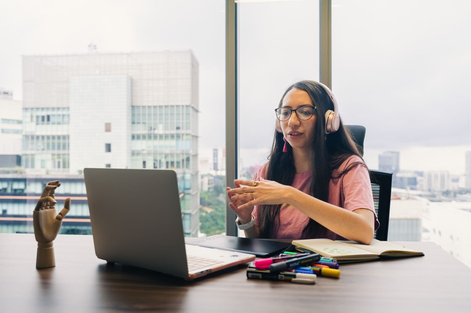 Marketer on a call with headphones in a bright office