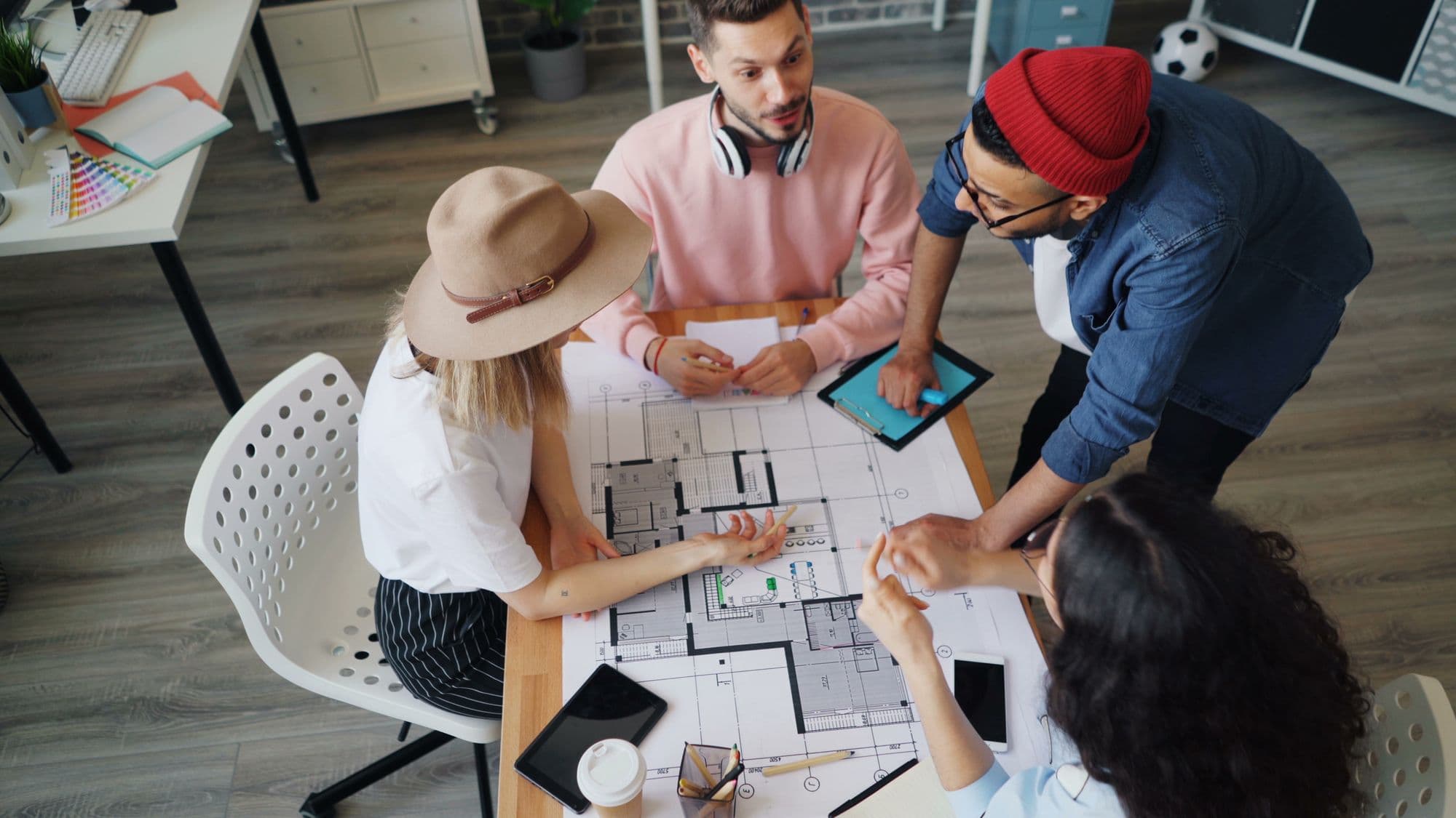 Design team reviewing layouts together around a table